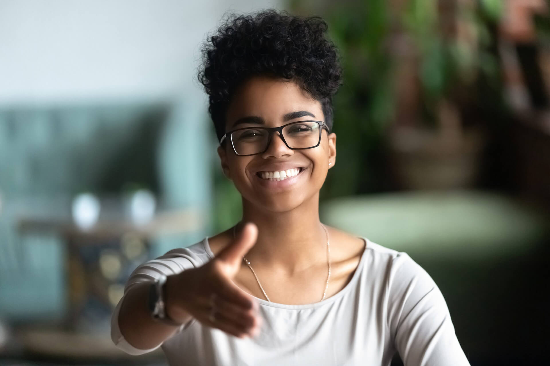 Smiling biracial young woman greeting introducing at meeting